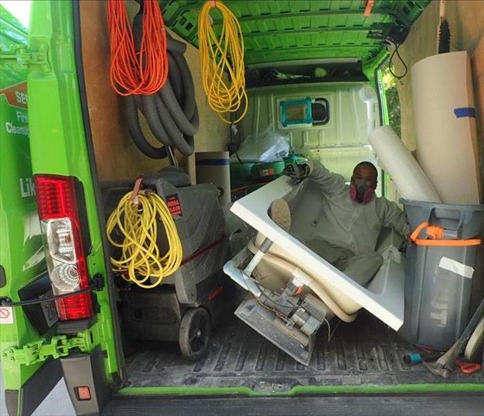 back on the van with team member inside in a tub