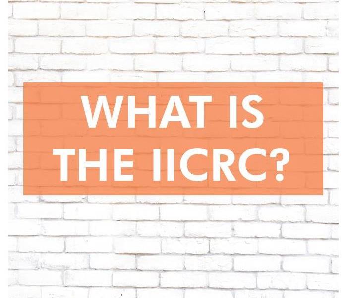 White brick wall with the words WHAT IS THE IICRC